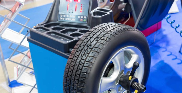 Computer wheel balancing on special machine. Tire service shop. Tyre tools and equipment